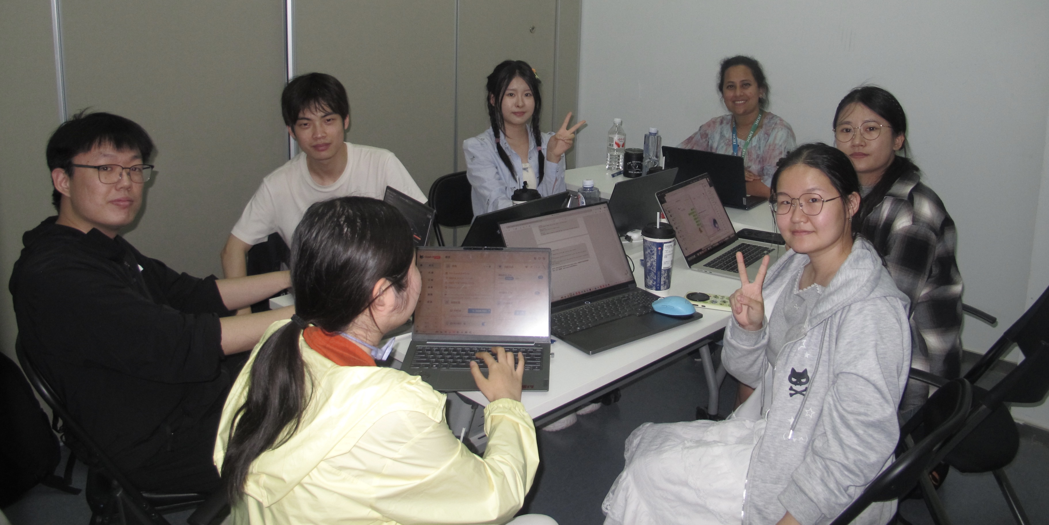 Shuhan and her classmates collaborating around a table